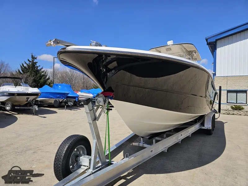 Slide: The Image of 2007 Triton 351 CC boat on a trailer in a marina under a clear blue sky. - 20