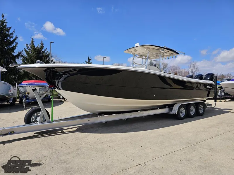 Slide: The Image of 2007 Triton 351 CC boat on a trailer under a clear blue sky. - 21