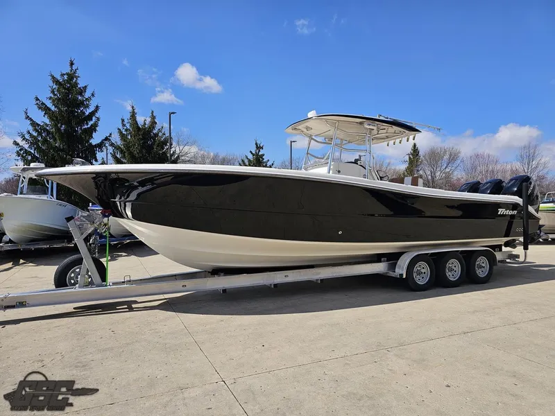 Slide: The Image of 2007 Triton 351 CC boat on a triple-axle trailer in a parking lot. - 22