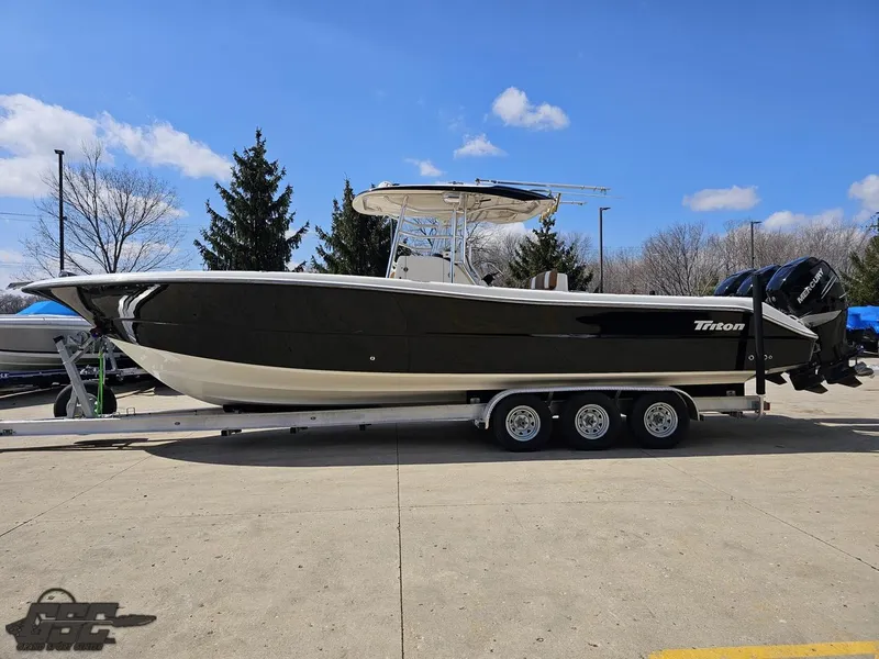 Slide: The Image of 2007 Triton 351 CC boat on a trailer in a parking lot. - 24