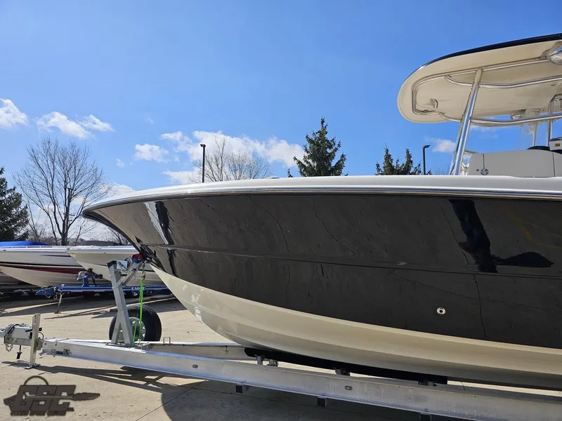 Slide: The Image of 2007 Triton 351 CC boat on a trailer under a clear blue sky. - 26