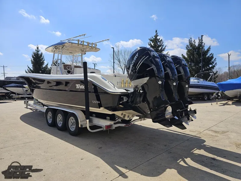 Slide: The Image of 2007 Triton 351 CC boat on a trailer with triple outboard engines. - 28