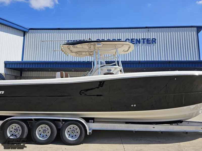 Slide: The Image of 2007 Triton 351 CC boat on a trailer outside a marine service center. - 3