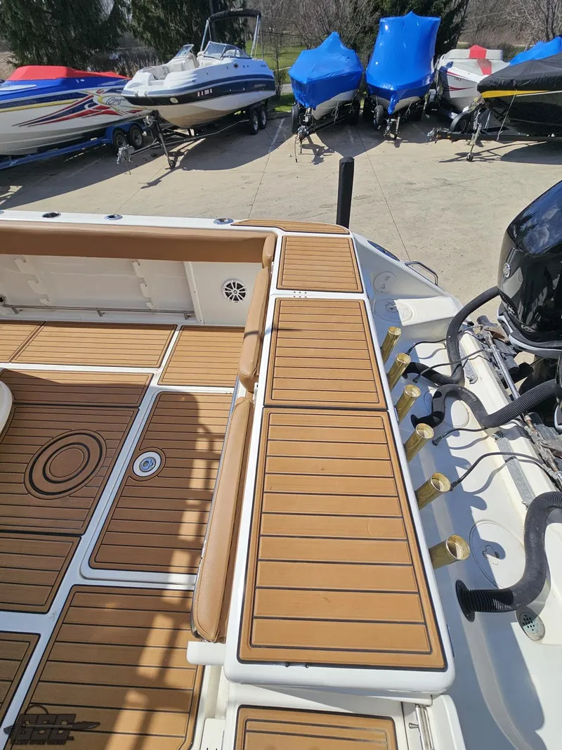 Slide: The Image of 2007 Triton 351 CC boat with teak deck, docked among other boats. - 31
