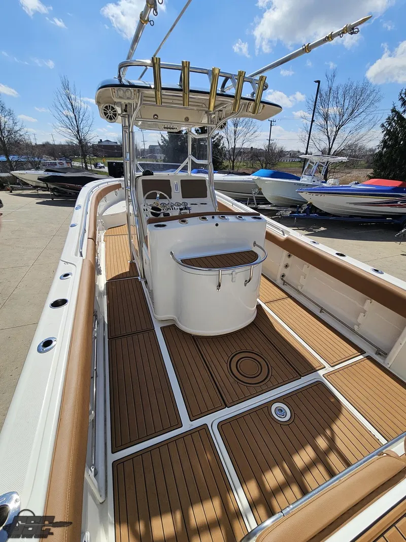 Slide: The Image of 2007 Triton 351 CC boat with teak deck and center console. - 32