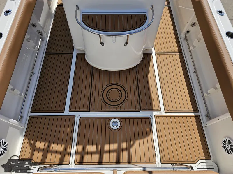 Slide: The Image of 2007 Triton 351 CC boat deck with teak flooring and white console. - 35