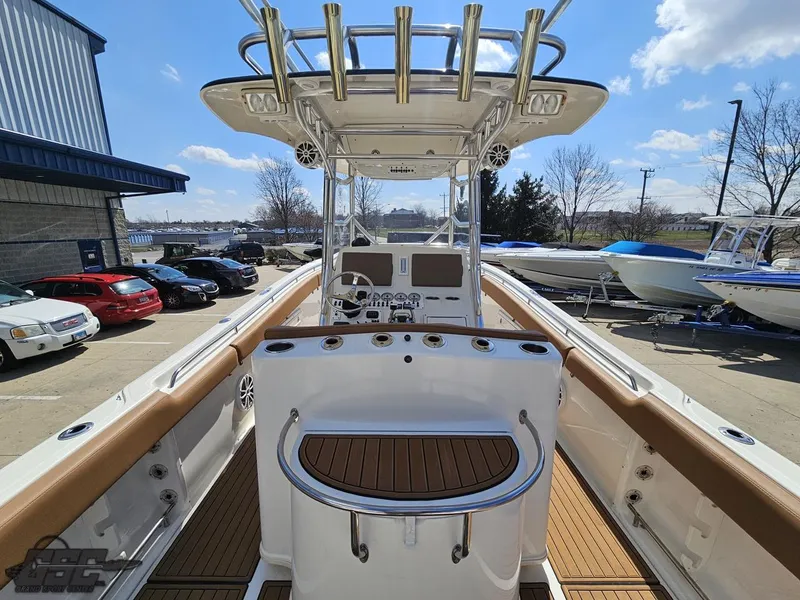 Slide: The Image of 2007 Triton 351 CC center console boat with helm station and rod holders. - 37