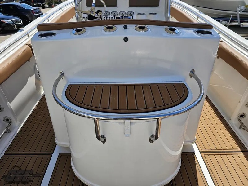 Slide: The Image of 2007 Triton 351 CC boat console with teak accents and rod holders. - 39