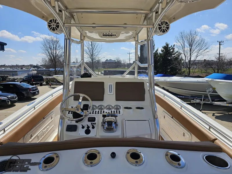 Slide: The Image of 2007 Triton 351 CC boat dashboard and controls on a sunny day. - 40