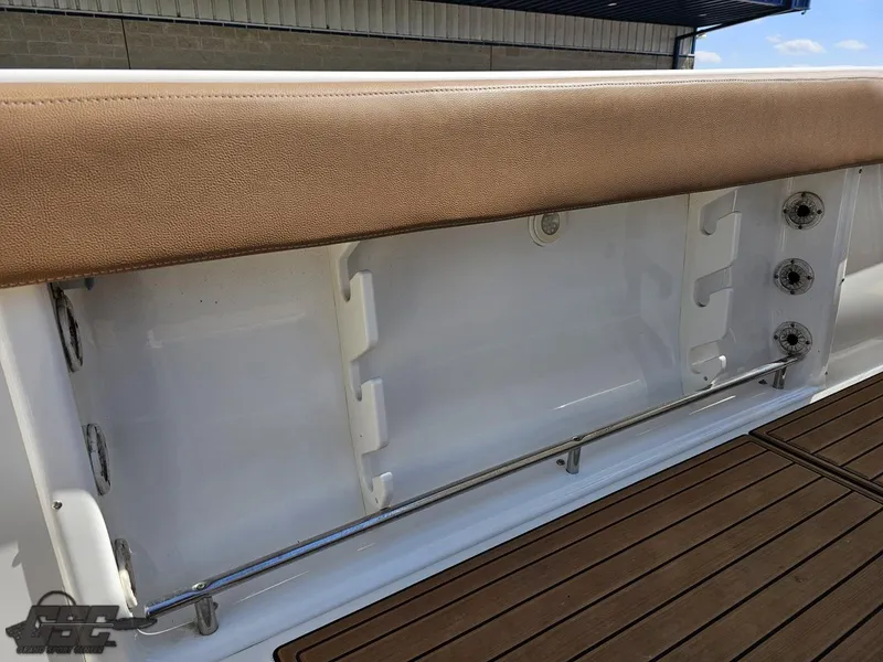 Slide: The Image of 2007 Triton 351 CC boat interior with cushioned seating and rod holders. - 43