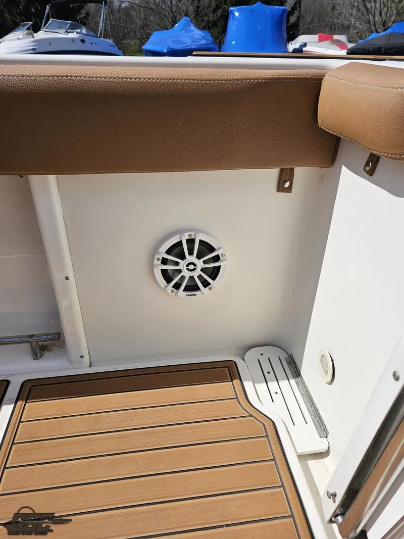 Slide: The Image of 2007 Triton 351 CC boat interior with speaker and teak flooring. - 44
