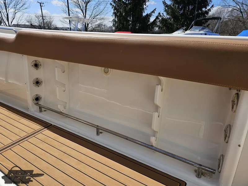 Slide: The Image of 2007 Triton 351 CC boat interior with tan upholstery and wooden deck. - 45