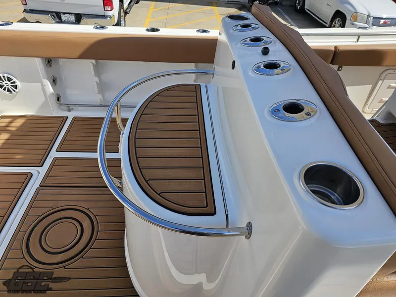 Slide: The Image of 2007 Triton 351 CC boat deck with rod holders and teak flooring. - 46