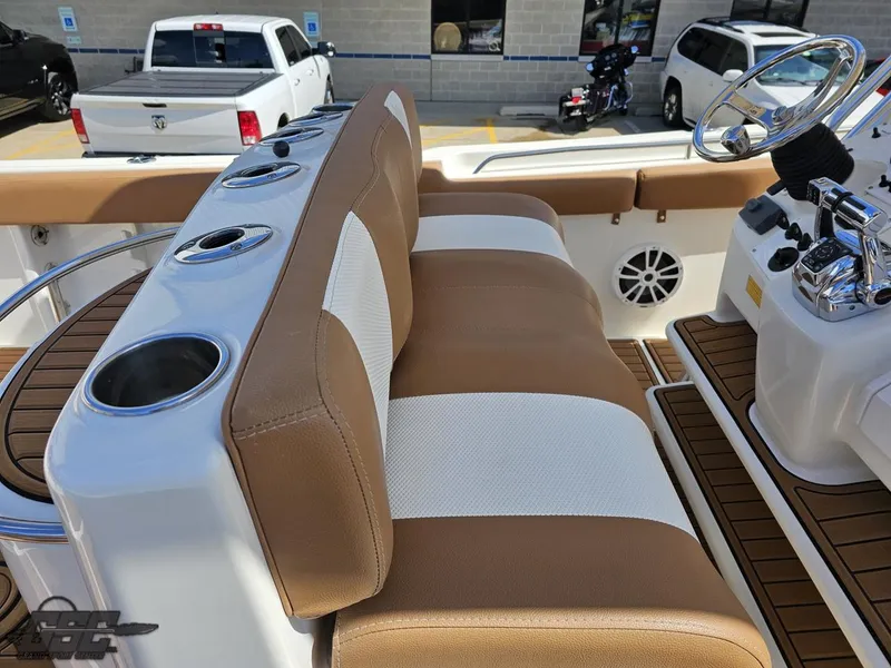 Slide: The Image of 2007 Triton 351 CC boat interior with tan and white seating, cup holders, and steering console. - 47