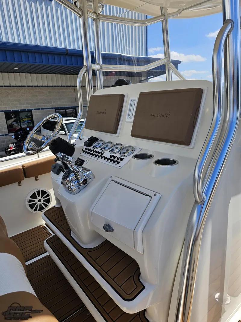 Slide: The Image of 2007 Triton 351 CC boat console with steering wheel and controls. - 48