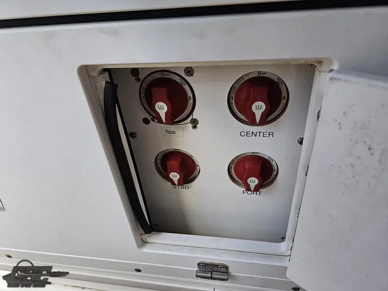 Slide: The Image of 2007 Triton 351 CC boat control panel with red switches labeled Center, Stbd, and Port. - 49