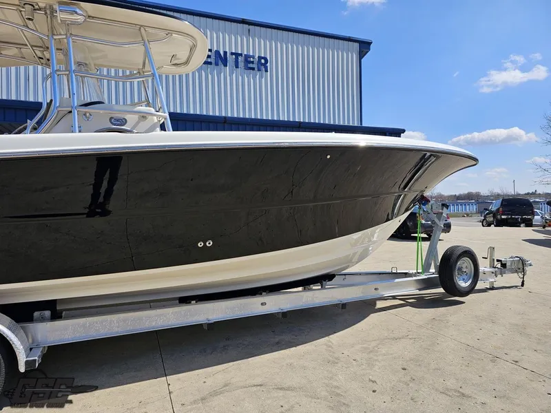 Slide: The Image of 2007 Triton 351 CC boat on a trailer outside a marine center. - 6
