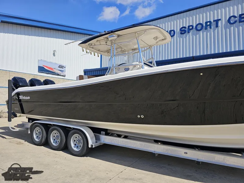 Slide: The Image of 2007 Triton 351 CC boat on a trailer outside a marine sport center. - 8
