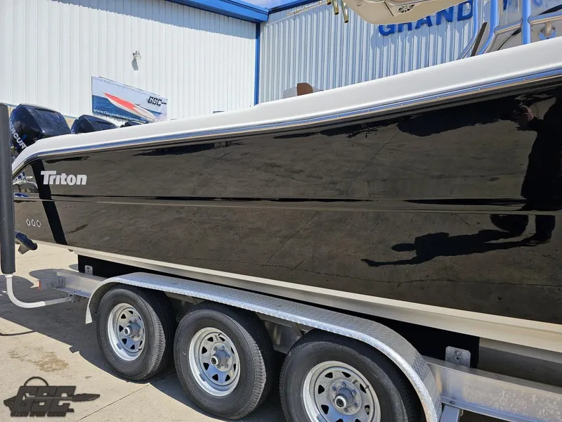 Slide: The Image of 2007 Triton 351 CC boat on a triple-axle trailer. - 9