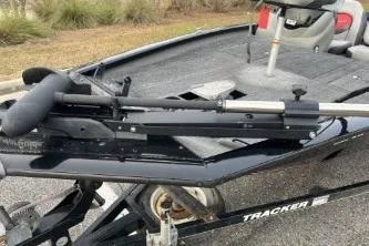 Slide: The Image of 2015 Tracker Pro Team 175 TXW boat on trailer, featuring a sleek black design. - 2
