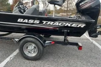 Slide: The Image of 2015 Tracker Pro Team 175 TXW bass boat on trailer in parking lot. - 3