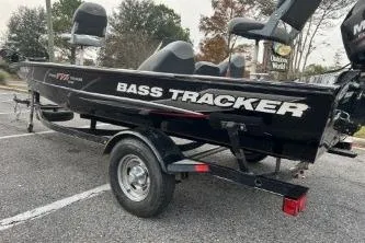 Slide: The Image of 2015 Tracker Pro Team 175 TXW bass boat on trailer in parking lot. - 5