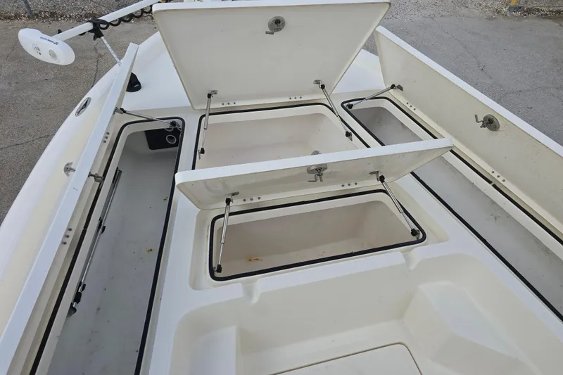 Slide: The Image of 2021 Skeeter SX240 boat with open storage compartments on deck. - 10