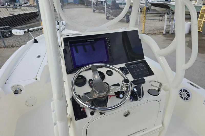 Slide: The Image of 2021 Skeeter SX240 boat console with steering wheel and navigation display. - 12