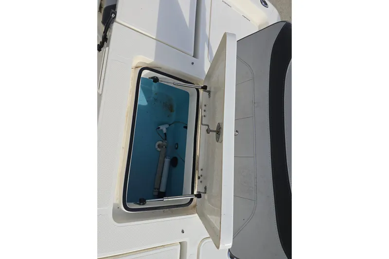 Slide: The Image of Open storage compartment on 2021 Skeeter SX240 boat, showing interior details. - 15