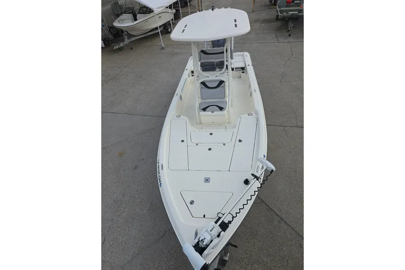 Slide: The Image of 2021 Skeeter SX240 boat with T-top and spacious deck, parked on concrete. - 8