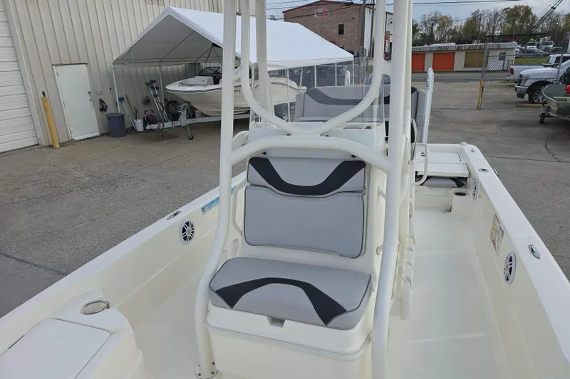 Slide: The Image of 2021 Skeeter SX240 boat interior with seating and console, parked outdoors. - 9