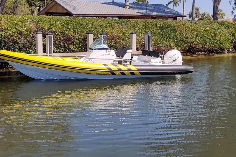 Slide: The Image of Yellow and black Arctic Blue 29 boat, 2019 model, docked on calm water. - 10