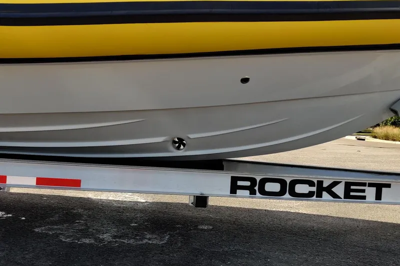 Slide: The Image of 2019 Arctic Blue 29 boat on Rocket trailer, yellow and white hull. - 12