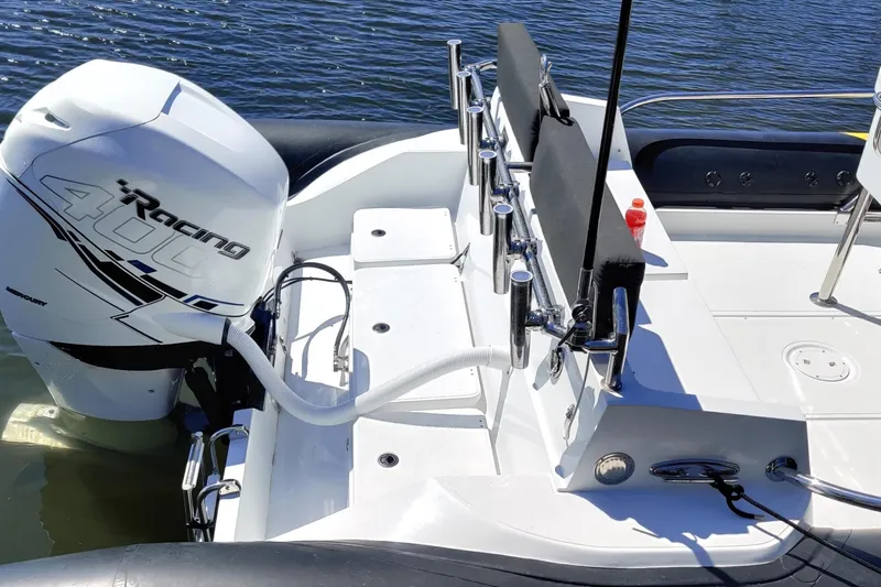 Slide: The Image of 2019 Arctic Blue 29 boat with Mercury Racing 400 engine on calm water. - 4