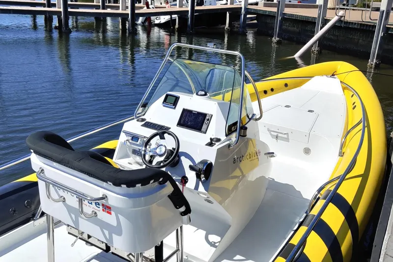 Slide: The Image of 2019 Arctic Blue 29 boat with yellow trim docked at marina. - 6