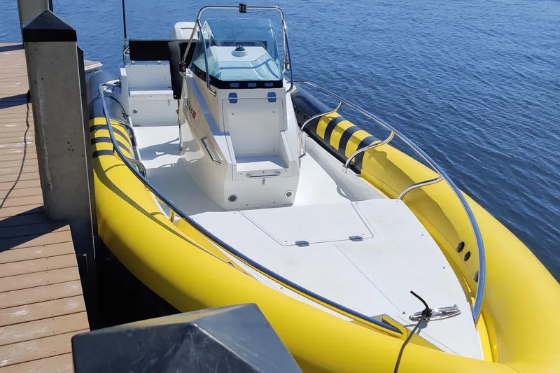 Slide: The Image of Yellow Arctic Blue 29 boat docked on calm water, 2019 model. - 9