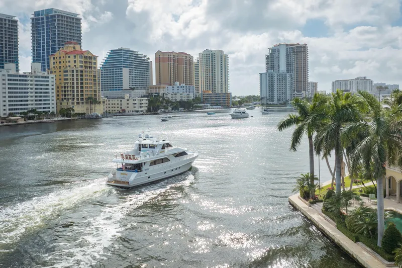 Slide: The Image of 2005 Ocean Alexander 80 Motoryacht cruising in a sunny urban waterway with skyscrapers. - 106