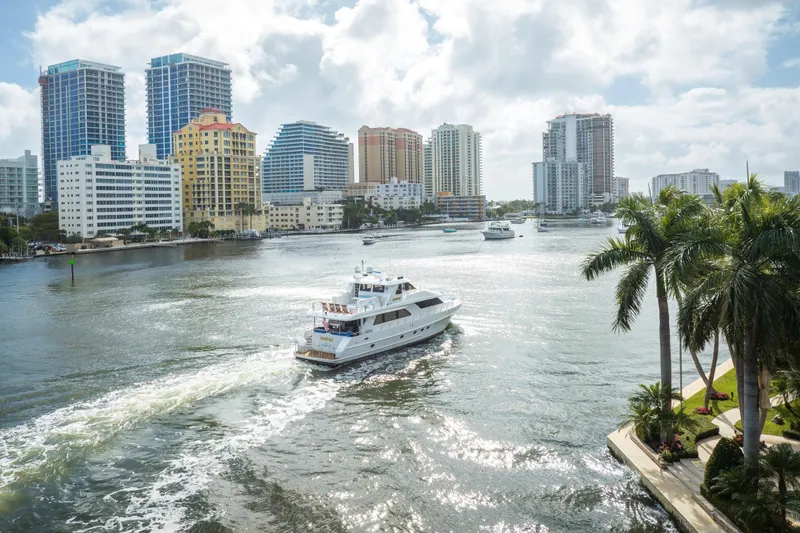 Slide: The Image of 2005 Ocean Alexander 80 Motoryacht cruising in a sunny urban waterway with skyscrapers. - 107