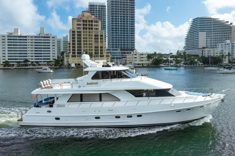 Slide: The Image of 2005 Ocean Alexander 80 Motoryacht cruising in a city harbor with skyscrapers in the background. - 109