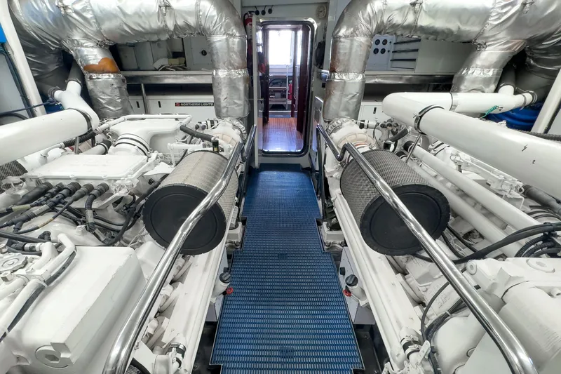 Slide: The Image of Engine room of 2005 Ocean Alexander 80 Motoryacht with dual engines and metallic piping. - 119