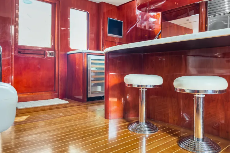 Slide: The Image of Luxurious interior of 2005 Ocean Alexander 80 Motoryacht with polished wood and modern bar stools. - 34