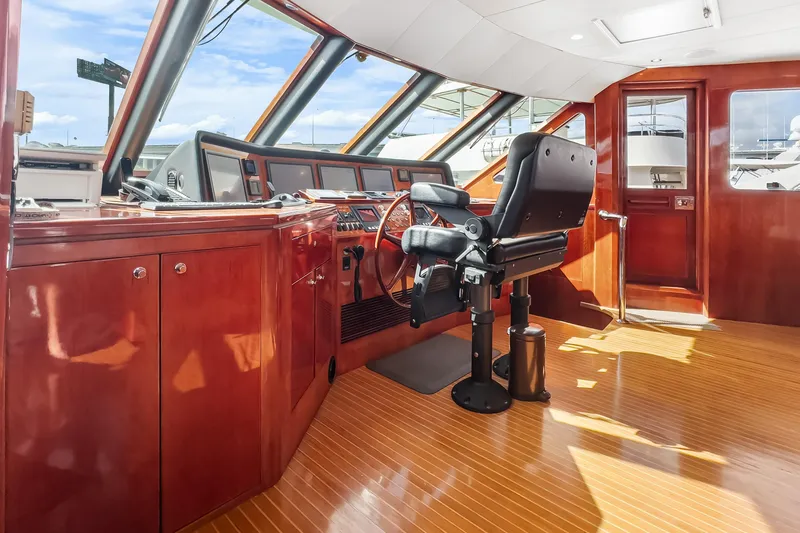 Slide: The Image of Luxurious helm of 2005 Ocean Alexander 80 Motoryacht with polished wood finish. - 44