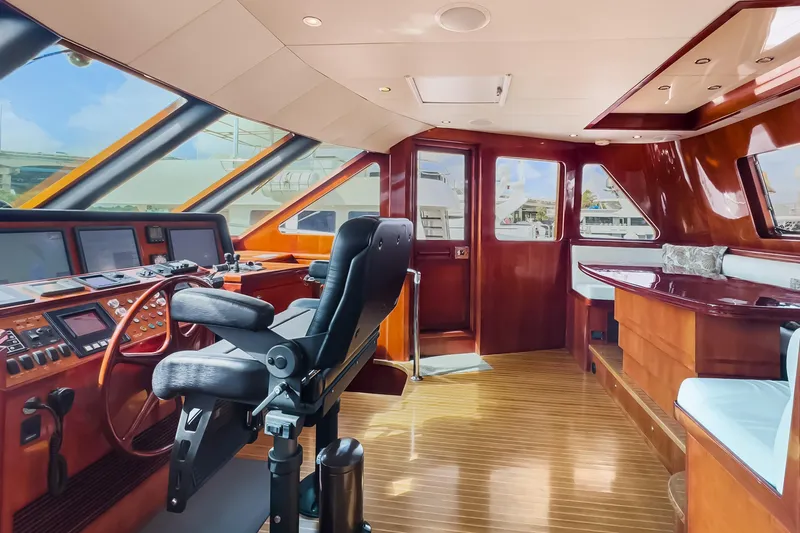 Slide: The Image of Luxurious helm of 2005 Ocean Alexander 80 Motoryacht with polished wood and modern controls. - 45
