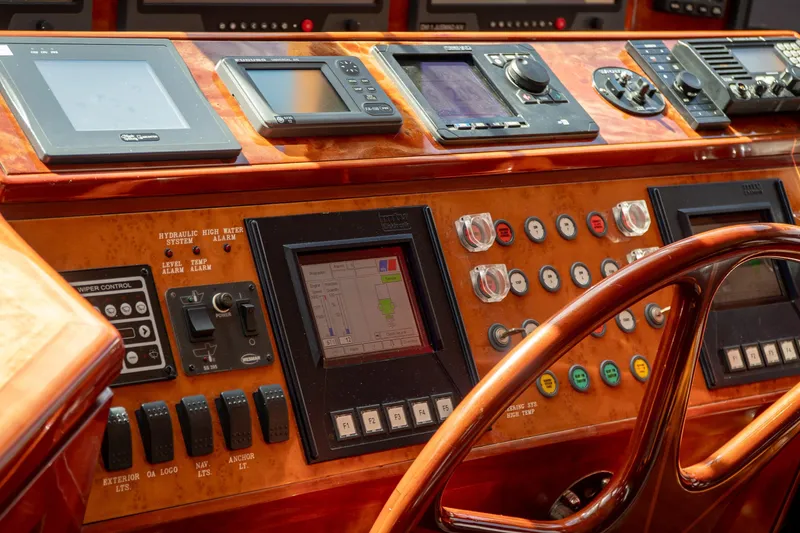 Slide: The Image of Control panel of a 2005 Ocean Alexander 80 Motoryacht with navigation instruments and steering wheel. - 48