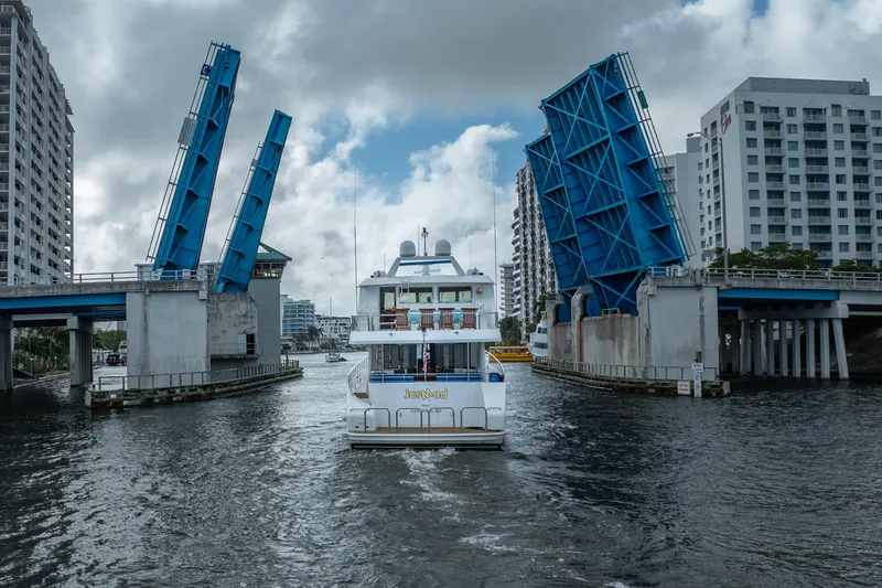 Slide: The Image of Ocean Alexander 80 Motoryacht (2005) passing through raised drawbridge in urban waterway. - 59