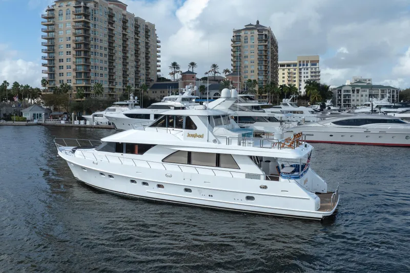 Slide: The Image of 2005 Ocean Alexander 80 Motoryacht docked in a marina with cityscape background. - 74