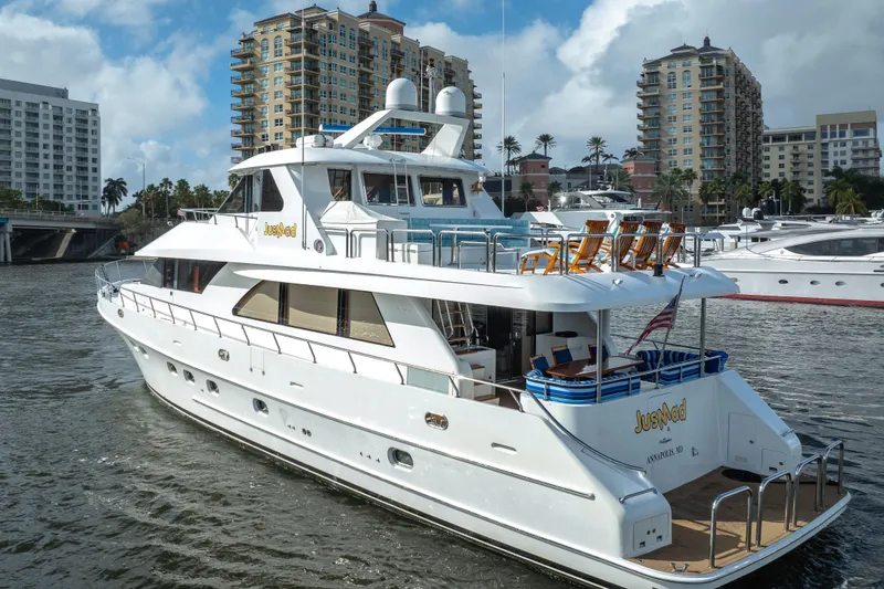 Slide: The Image of Luxury 2005 Ocean Alexander 80 Motoryacht docked in a marina, surrounded by buildings. - 75
