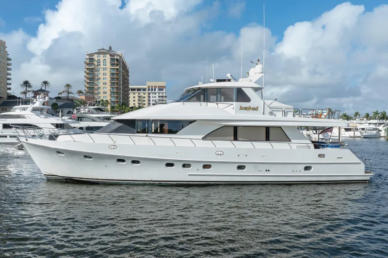 Slide: The Image of 2005 Ocean Alexander 80 Motoryacht docked in a marina with cityscape background. - 78