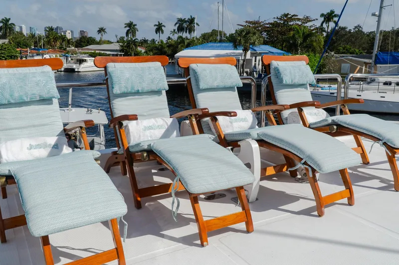 Slide: The Image of Deck chairs on 2005 Ocean Alexander 80 Motoryacht, docked with scenic waterfront view. - 8