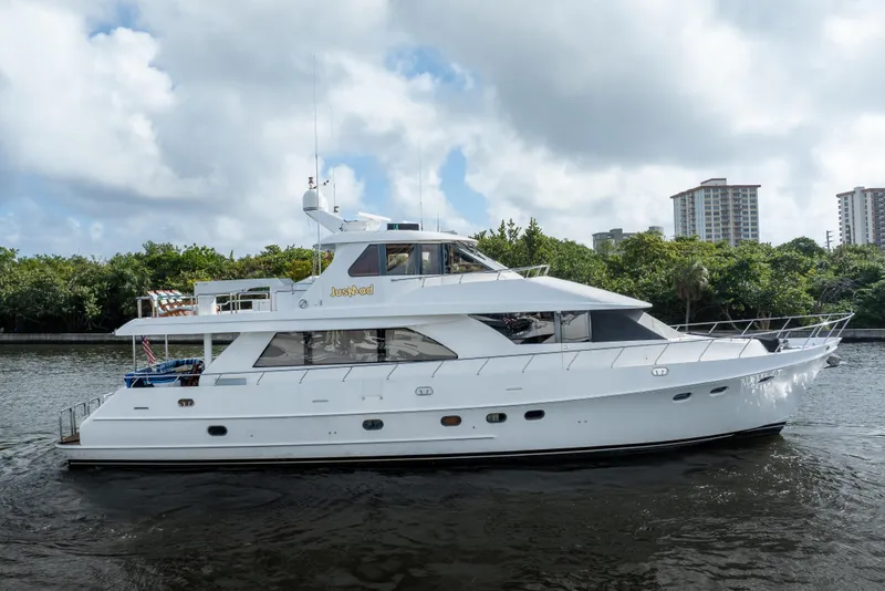 Slide: The Image of 2005 Ocean Alexander 80 Motoryacht cruising on a river with cityscape background. - 89